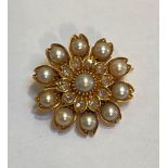 A seed pearl and diamond brooch, of flowerhead form, probably late 19th century, the central pearl