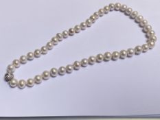 A single graduated strand of cultured pearls, of bouton shape, on a magnetic clasp set with CZs.