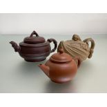 A group of Chinese Yixing teapots comprising: a ribbed example, the cover with mouse or rat