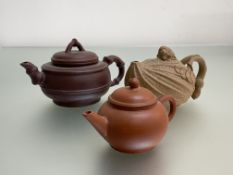 A group of Chinese Yixing teapots comprising: a ribbed example, the cover with mouse or rat
