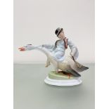 A Herend porcelain group of a boy in Tyrolean dress riding a goose, mid-20th century, blue printed