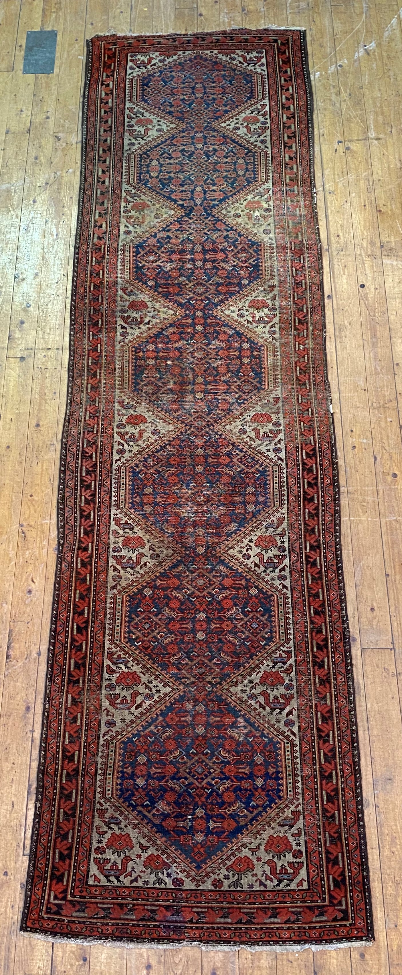 An old Caucasian runner rug, the central field with pole medallion and stylised bird motif, 407cm