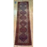 An old Caucasian runner rug, the central field with pole medallion and stylised bird motif, 407cm