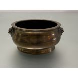 A Chinese bronze censer, of squat baluster form, cast with lion mask handles and with seal mark of