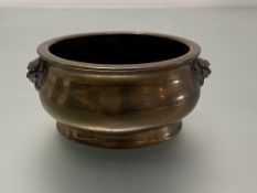 A Chinese bronze censer, of squat baluster form, cast with lion mask handles and with seal mark of