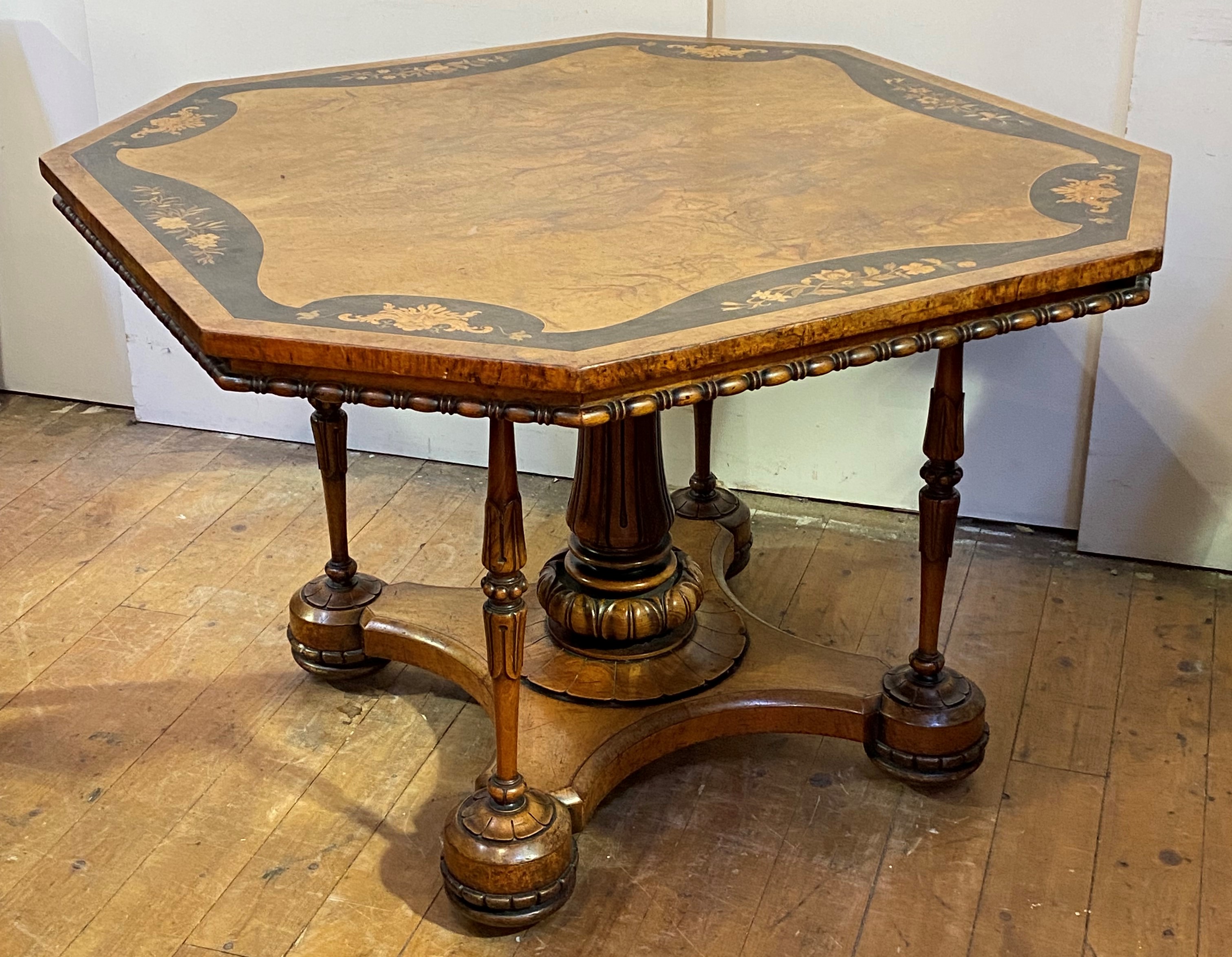 A Victorian walnut centre table, the octagonal top with quarter sawn veneer framed within an
