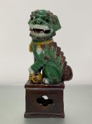 A well-modelled Chinese pottery Buddhistic lion in a Sancai glaze, 20th century, with open mouth and