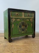 A Chinese green lacquered cabinet, two drawers over two cupboards opening to a shelf behind, the