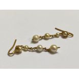 A pair of cultured pearl drop earrings, each with a collet-set half pearl suspending a chain with