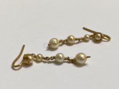 A pair of cultured pearl drop earrings, each with a collet-set half pearl suspending a chain with