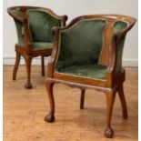 A pair of walnut drawing room tub chairs, circa 1930's, each with swept crest rail with parrot