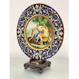 A 19th century Italian maiolica charger, the well painted with a mythological scene within a rim