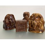 Two 19th century treacle-glazed lion mask sash window rests; together with a 19th century treacle-