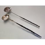 A George III white metal toddy ladle, c. 1800, with coin-inset oval bowl on a balleen twist