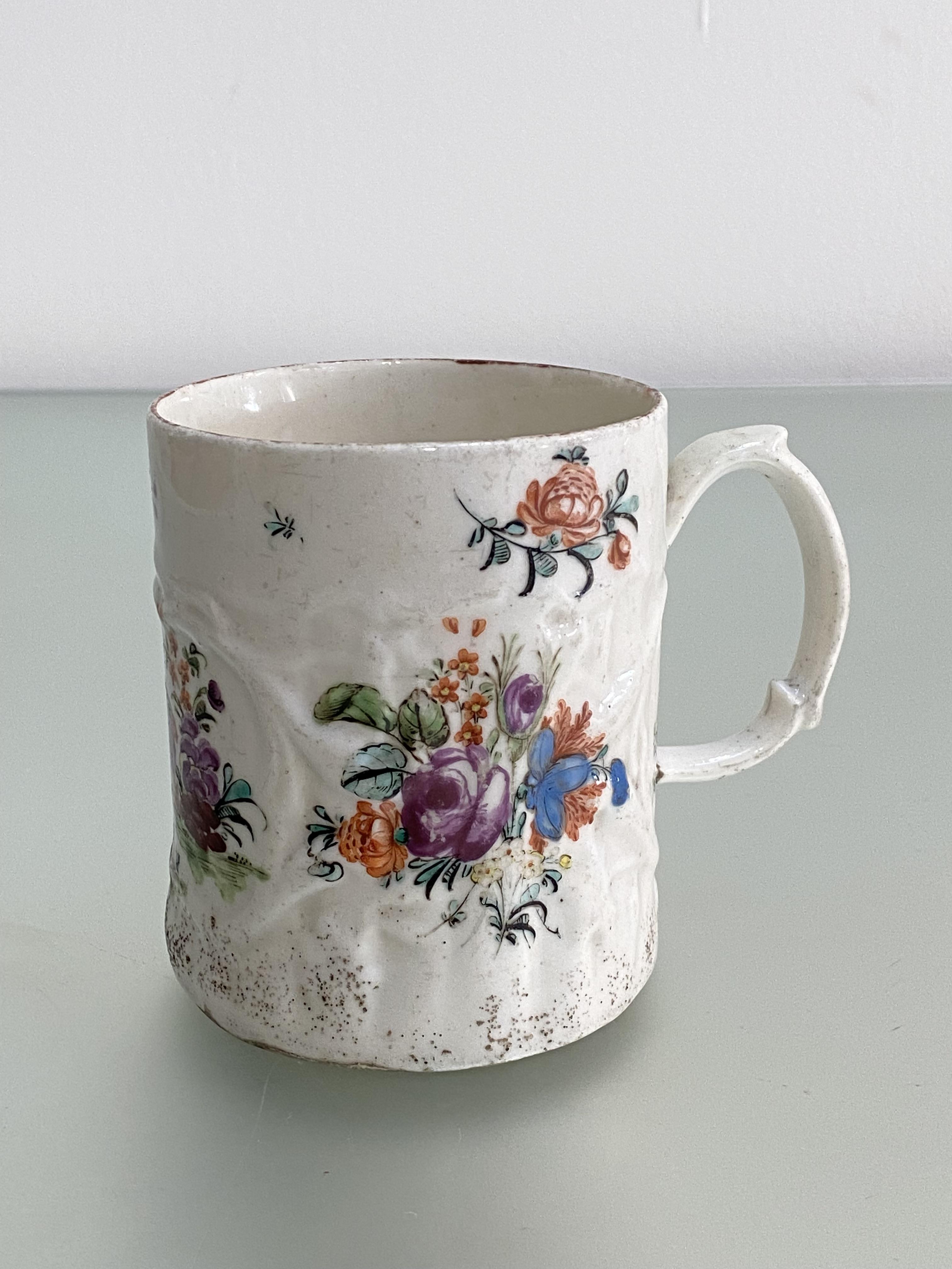 A rare West Pans porcelain mug, c. 1770, of cylindrical form, moulded with scrolling foliage and