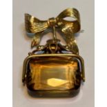 A 9ct gold and citrine brooch, formed of a swivelling fob suspended from a ribbon-tied brooch,