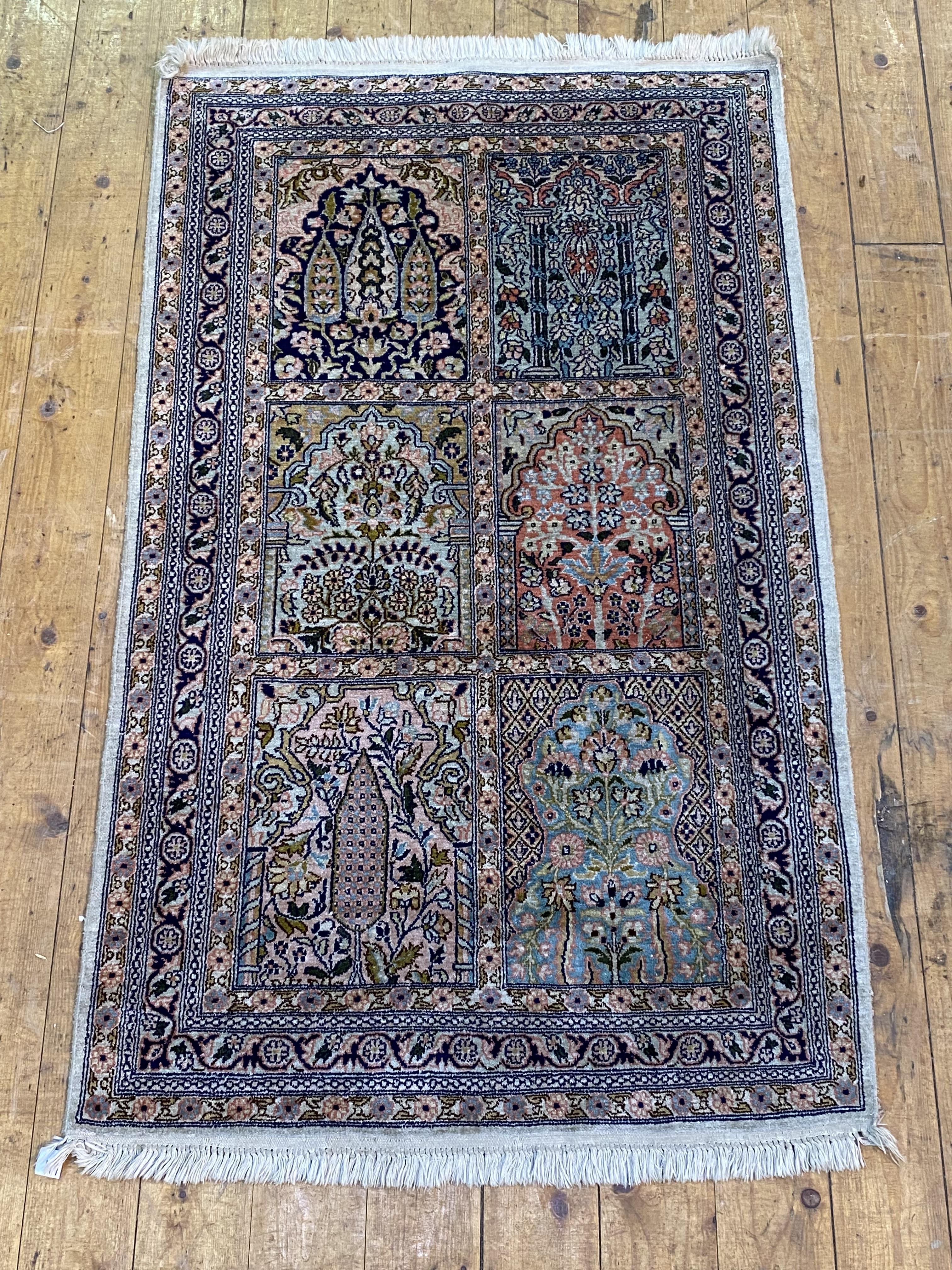 A Persian silk pile garden rug, with multiple panels depicting foliage within mihrabs, within