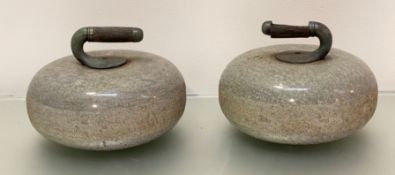 A pair of granite curling stones, each with wooden-inset handle (wood distressed). Diameter 27cm