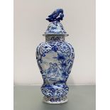 A Dutch Delft vase and cover, late 19th century, of baluster form, painted and moulded with