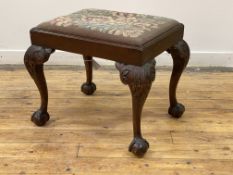 A late 19th century mahogany footstool of Chippendale design, the needlepoint upholstered drop in