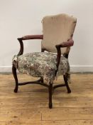 An elegant George III mahogany elbow chair, late 18th century, the shaped back over open arms with