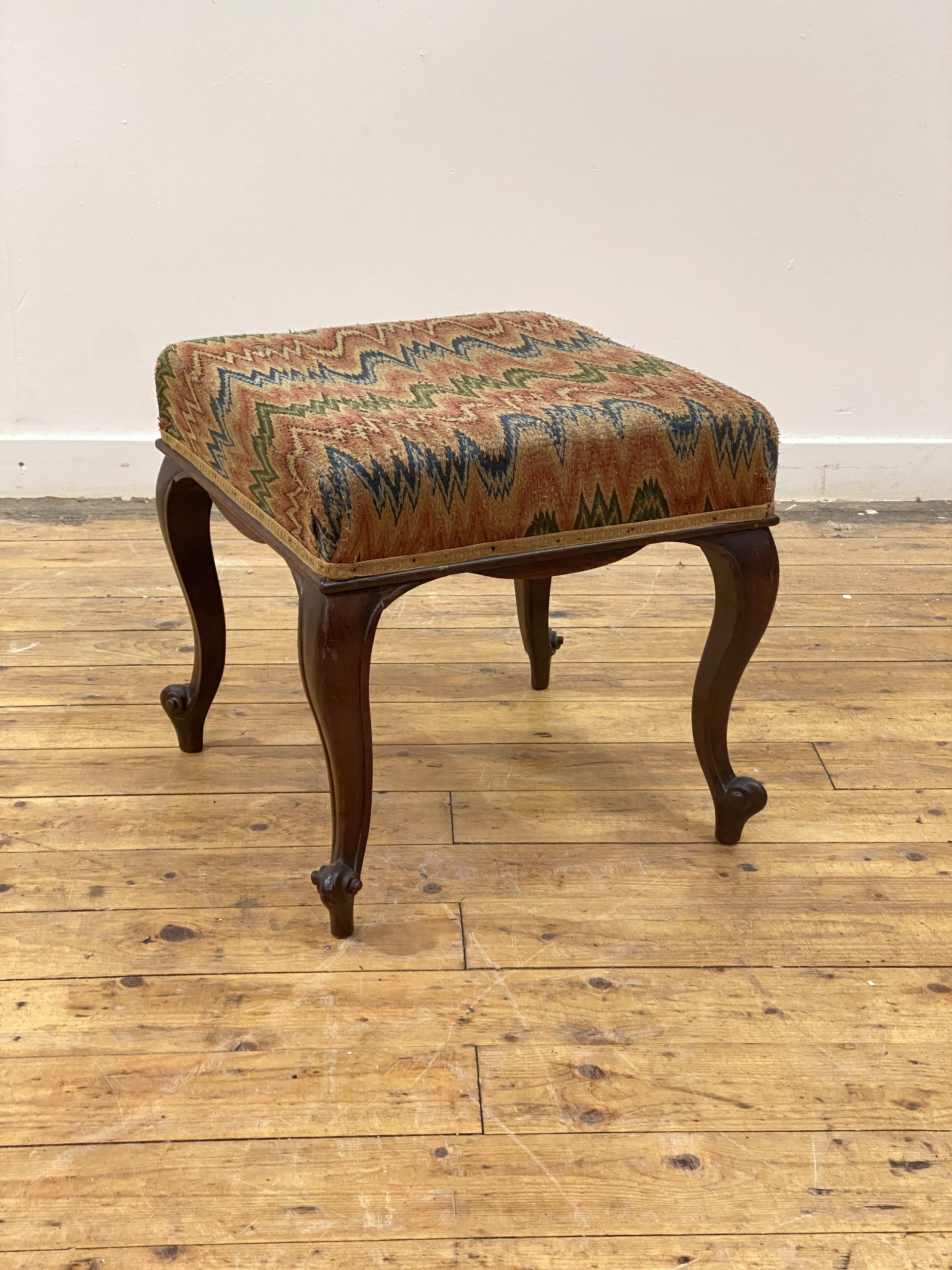 A Victorian rosewood footstool, the square top covered in later fabric above a serpentine apron,