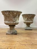 A pair of composition stone garden urns, of campana form, each with flared rim over a body