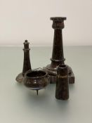 A group of late 19th/early 20th century serpentine desk ornaments comprising: a candlestick, the