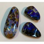 A large unmounted boulder opal (47mm by 7mm) and a matched pair (approx. 26mm by 15mm). (3)