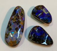 A large unmounted boulder opal (47mm by 7mm) and a matched pair (approx. 26mm by 15mm). (3)