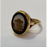 An 18ct gold micro mosaic ring, the oval plaque depicting the Temple of Vesta, mounted on split