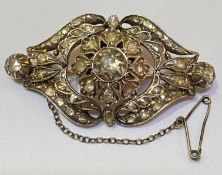 A mid-19th century diamond brooch, mounted in yellow gold and silver, of shaped lozenge form, the