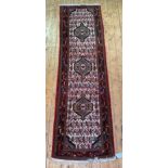 A Persian Hamadan runner rug, hand knotted, with triple medallion on ivory field framed within