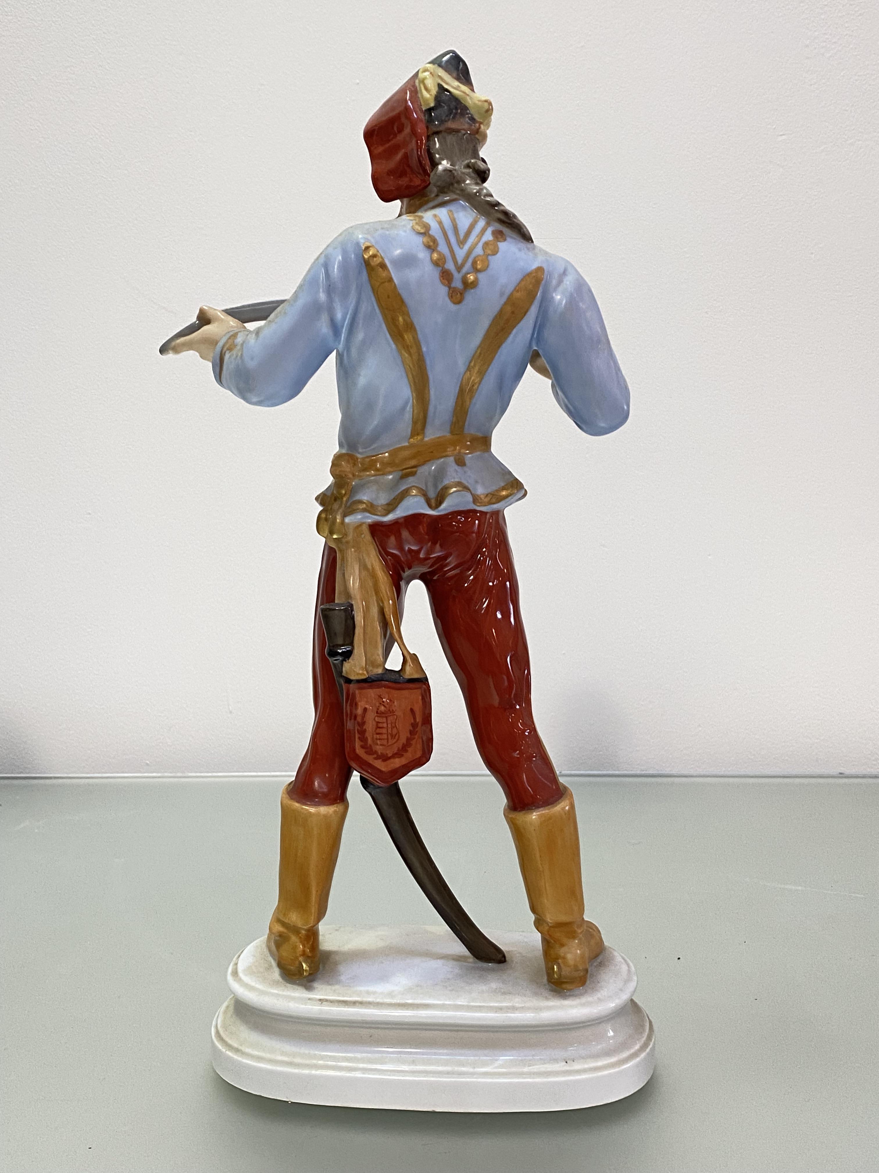 A large Herend porcelain figure of a Hadik Hussar, on an integral oval plinth, blue printed, stamped - Image 2 of 3