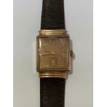 A Longines 10k gold-filled gentleman's wristwatch, c. 1930-40, the rectangular copper finish dial