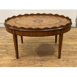 A Georgian design inlaid mahogany low table, the oval top with scalloped tray edge enclosing an