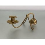 In the manner of W.A.S. Benson, an Arts & Crafts brass counterweight candlestick, the spherical