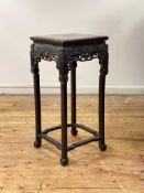 A late 19th century Chinese hardwood jardiniere stand, the square top with breche violette panel