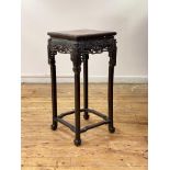 A late 19th century Chinese hardwood jardiniere stand, the square top with breche violette panel