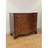 A George III mahogany chest of serpentine outline, circa 1800, the top with boxwood stringing to