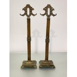 A pair of brass andirons, c. 1920, cast with scrolls and flowerheads, on rectangular bases and