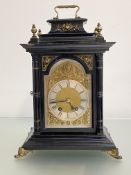A late 19th century gilt-metal mounted ebonised bracket clock, the silvered chapter ring with