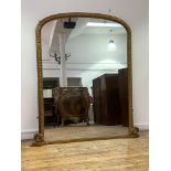 A large Victorian gilt framed arched overmantel mirror, the frame with bead and oak leaf moulding,