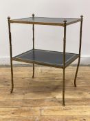 A mid 20th century brass faux bamboo two tier etagere, each tier inset with gilt tooled leather,