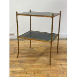 A mid 20th century brass faux bamboo two tier etagere, each tier inset with gilt tooled leather,