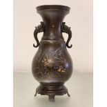 A Japanese mixed metal and bronze twin-handled vase, Meiji period, c. 1900, of baluster form, with