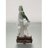 A Chinese jadeite carving of a female Immortal standing beside a crane, a flowering bough in her