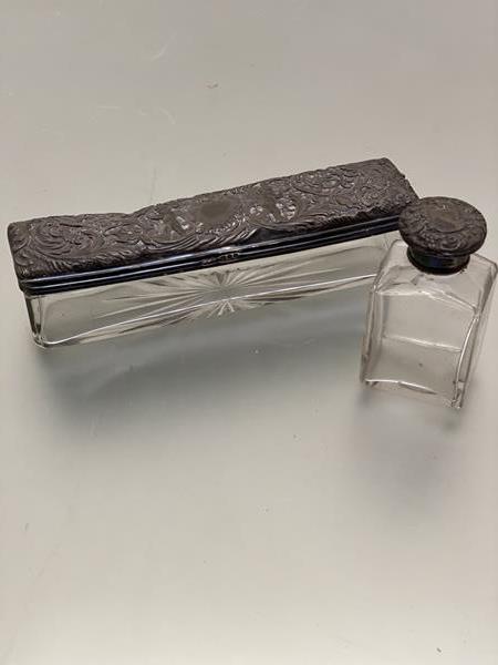A Mappin & Webb silver chased top glass pin box and a silver mounted bottle (box: 4cm x 18cm) (2)