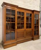 An Edwardian mahogany inverted break front bookcase, the moulded top over centre fitted with two