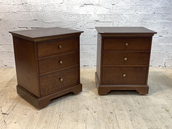 A pair of cherry three drawer bedside chests on castors H70cm, W58cm, D46cm